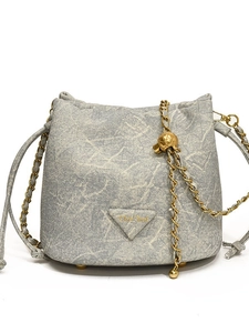Fashionable blue denim bucket bag with gold chain strap and marble texture pattern