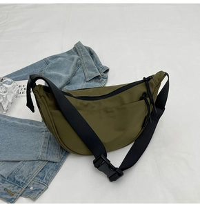 Detail view of olive green crescent bag with adjustable strap and durable plastic buckle