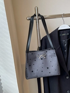 Chic gray underarm bucket bag with star prints and silver bow detail on hanger