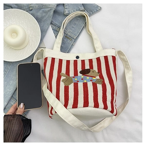 Détail du sac seau en toile rayée rouge avec broderie et bandoulière amovible