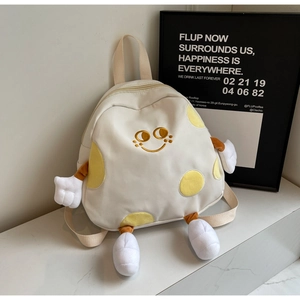 Detailed view of white cartoon canvas backpack with 3D limb features and smiley face