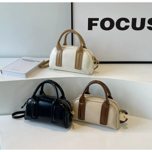 Detail view of stylish Boston bags in various colors with premium matte leather finish