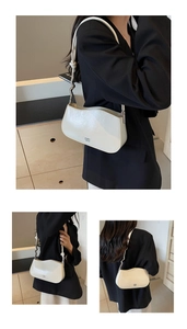 Detail showing wavy rim ivory shoulder bag with metallic knot and polished finish