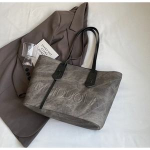 Close-up of the dark grey washed leather tote bag with Meiduola embossed branding