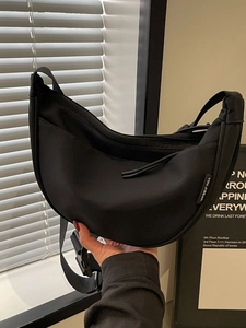 Black waterproof nylon crescent crossbody bag with adjustable strap for daily use