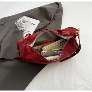 Detailed interior of red quilted leather hobo bag showing large capacity for daily items