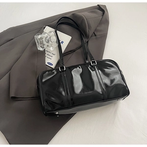 Top view of a black patent leather shoulder bag with silver hardware and dual handles