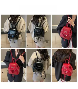 Detail of mini PU leather backpack with metallic bow and drawstring in black and red