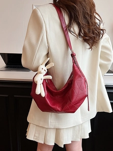 Red geometric embossed crossbody dumpling bag for women with a cute bunny charm