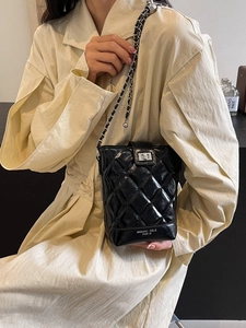 Chic black quilted chain bucket bag with shiny finish and adjustable strap
