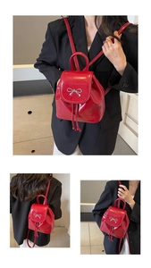 Red patent leather mini backpack with silver bow buckle and drawstring flap closure