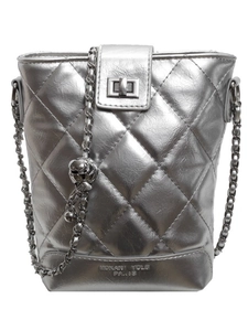 Silver quilted bucket bag with chain strap and metallic lock on a white background