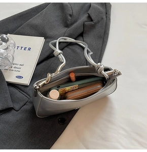 Interior view of the silver shoulder bag showing storage for phone and wallet