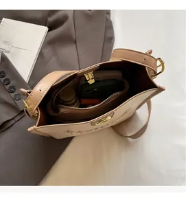 Top view of spacious interior with zipper pocket showing phone and makeup storage