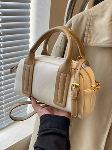 Elegant cream and khaki Boston bag with gold hardware and adjustable strap for women