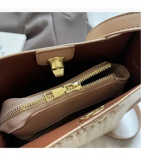 Detailed view of large tote bag interior featuring smooth metal zipper and turn-lock closure