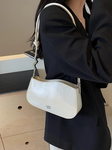 Minimalist cream white shoulder bag with unique wavy edges and stylish metal buckle