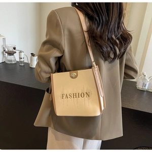 Detail of crossbody tote bag with gold Fashion embroidery and premium metal twist lock