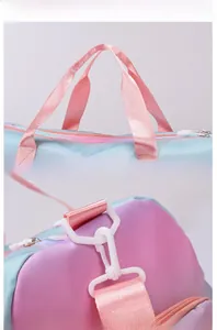 Detail view of pink and blue gradient travel bag with white zippers and nylon straps