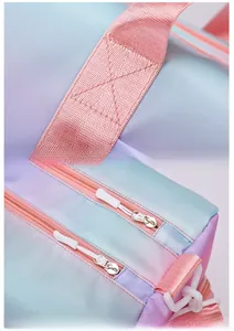 Detail of pink webbing handles with reinforced stitching and dual silver metal zippers