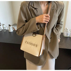 Detail of vintage bicolor tote bag with metal twist lock and fashion lettering print