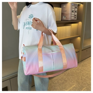 Detail of gradient blue and pink travel bag with reinforced handles and metal zipper