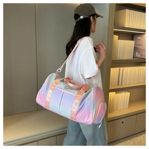 Rear view of model wearing the gradient pink and blue travel bag with wide shoulder strap