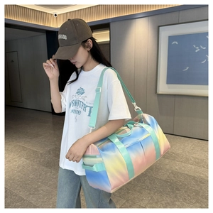 Gradient travel bag with adjustable strap shown being carried in a modern hallway