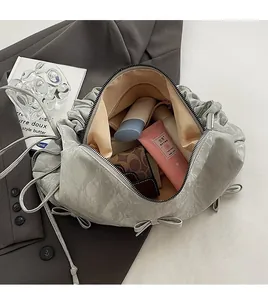 Detail view of spacious interior of pleated dumpling bag with smartphone and wallet
