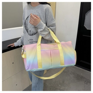 Detail of gradient travel bag with yellow straps showing shoulder carry size and pockets