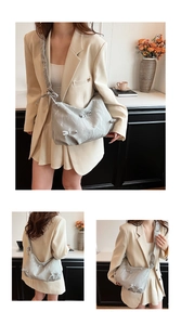 Detail view of silver pleated dumpling bag with stylish bow knots and metallic finish