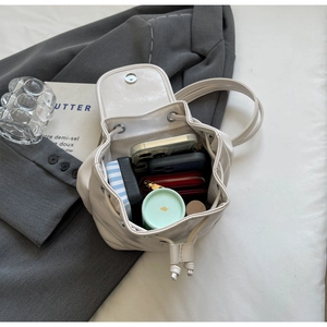 Internal view of cream drawstring backpack showing large capacity for essentials