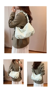 Detail of light green pleated handbag with bow and ruffled shoulder strap textures