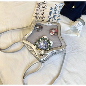 Détail du sac ita argenté en forme d'étoile avec fenêtre transparente et boucles en métal