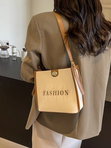 Beige tote bag with brown leather accents and FASHION embroidery for casual commuting
