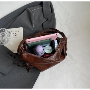 Top view of brown PU leather tote bag interior showing large capacity and daily items