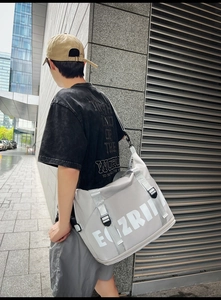 Rear view of a grey high-capacity Oxford cloth crossbody bag with ELZRII lettering