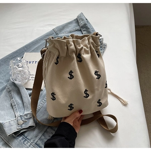 Sac seau tendance en toile blanc cassé avec broderie dollar et bandoulière marron
