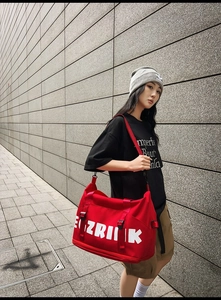 Close-up of red large-capacity Oxford travel bag with bold white EGZRIINK lettering details