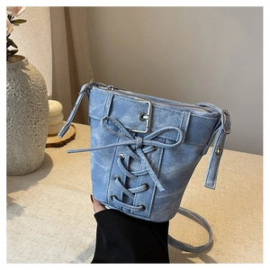 Nahaufnahme der hellblauen Denim-Beuteltasche mit Schnürung im Korsett-Stil und Metallschnalle