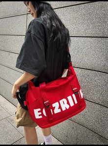 Close-up of red large-capacity Oxford travel bag with white EGZRIIK letter print