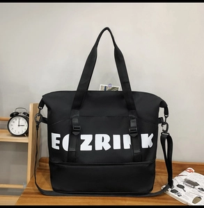 Detail of black waterproof travel bag featuring wet-dry separation shoe compartment