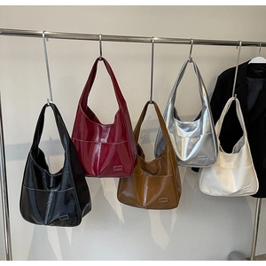 Detailed view of high-gloss large tote bags in five colors with white stitching details