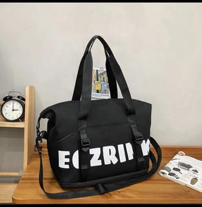 Detail of the large oxford cloth travel tote featuring the ECZRINK logo and strap