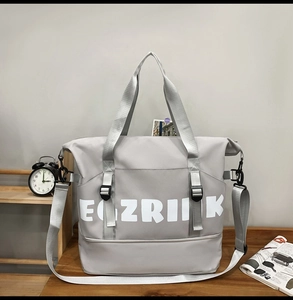 Close-up of grey Oxford fabric travel bag with adjustable strap and shoe compartment