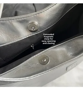 Detail view of the silver PU shoulder bag featuring a hidden magnetic closure and inner zip pocket