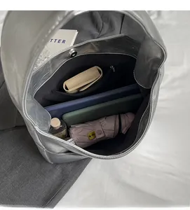 Macro view of silver tote bag interior showing large capacity and black fabric lining