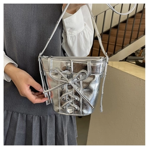 Details der silbernen Metallic-Beuteltasche mit Schnürung, Schleife und Schnalle