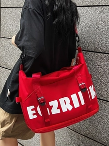 Large capacity red oxford cloth travel bag with white letters worn by a model