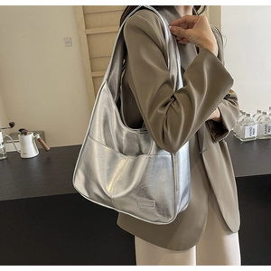 Close-up of silver Hobo bag with vintage crackle texture and metal finish on PU leather